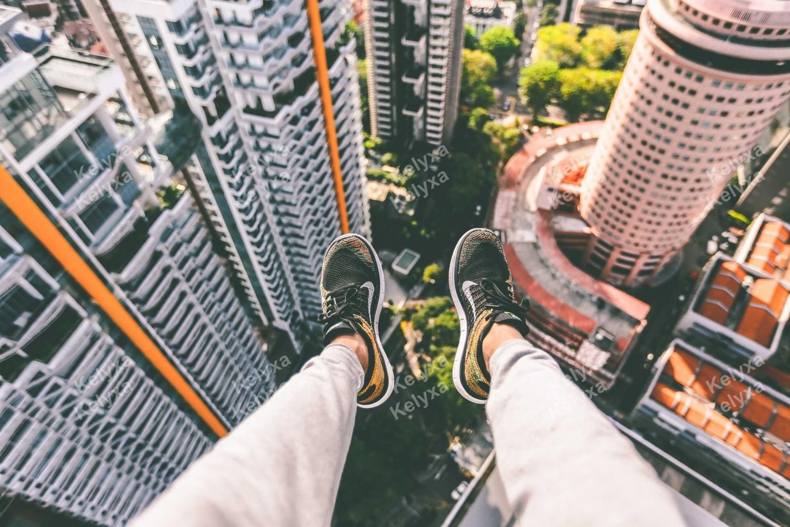 Dangling Feet Over City Skyline