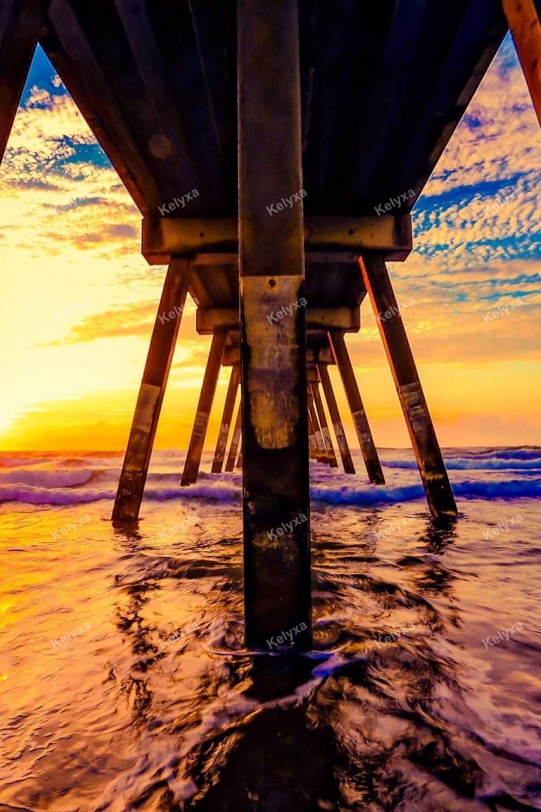 Wooden Pier Pilings At Colorful Sunset