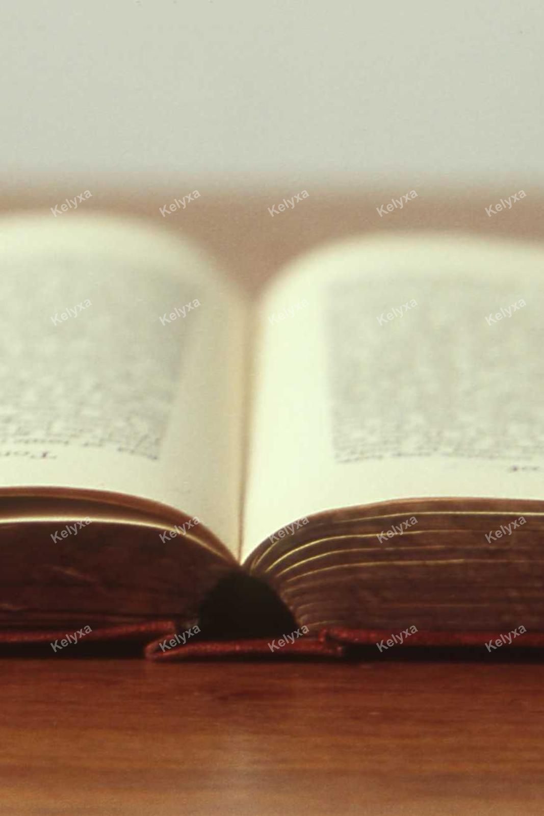 Open Antique Book on Wood Table