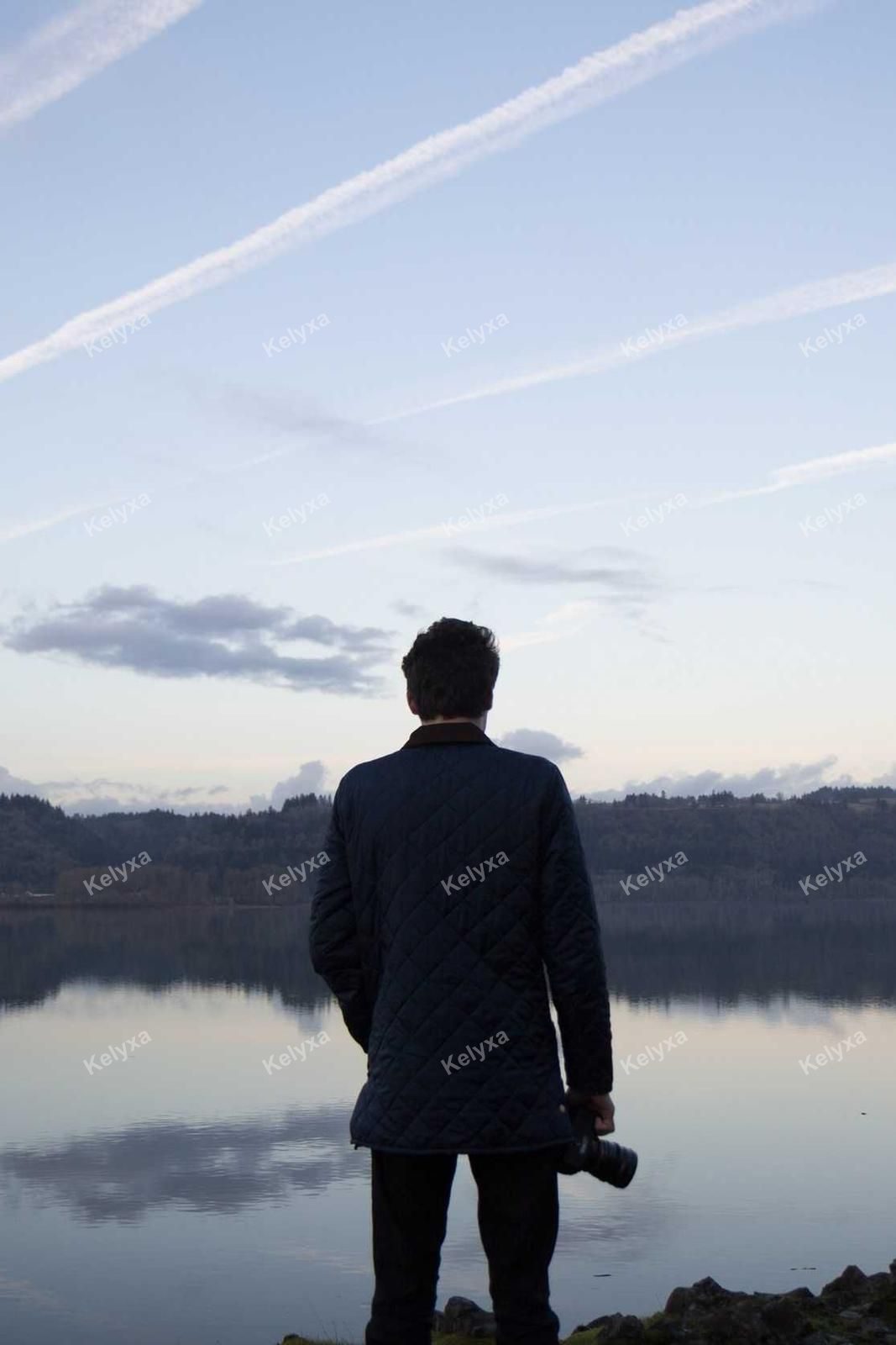Photographer Watching Lake At Dusk