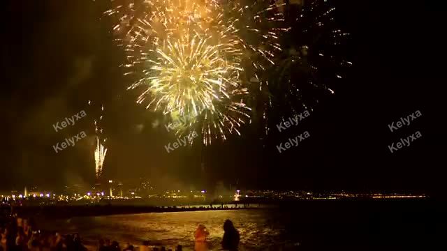 Fireworks Bursting Over Beach at Night