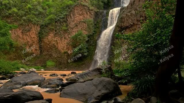 Waterfall Cascading Into Muddy Pool
