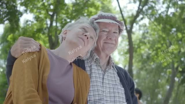 Elderly Couple Embracing Outdoors